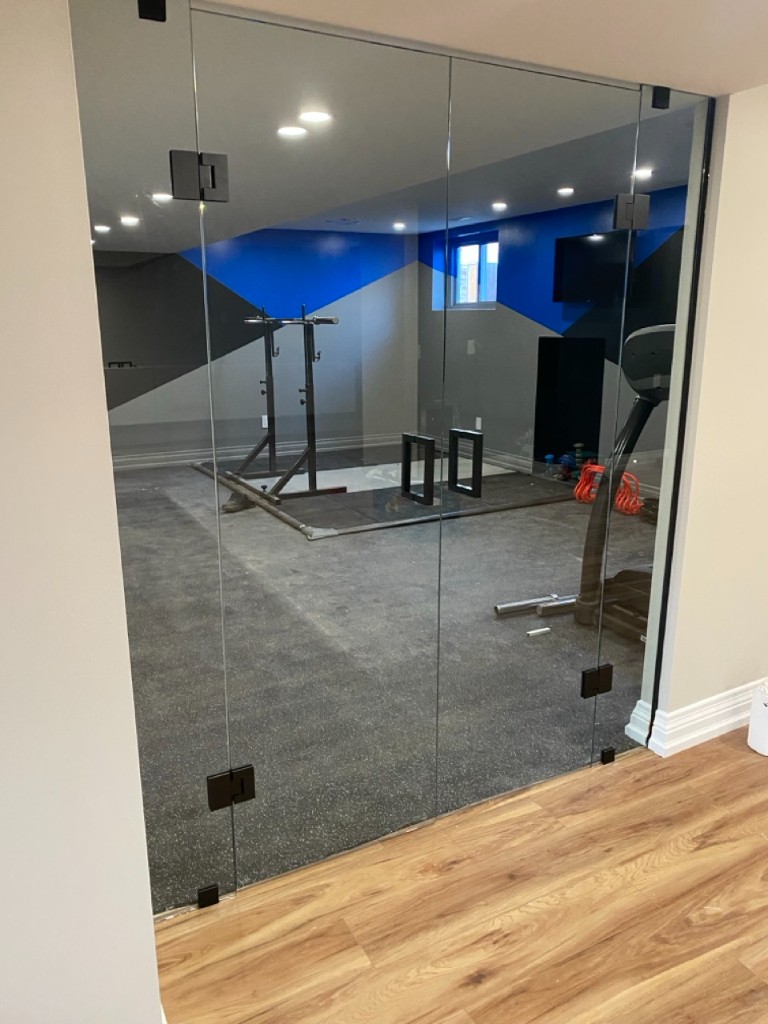 Frameless glass wall and doors for a commercial space
